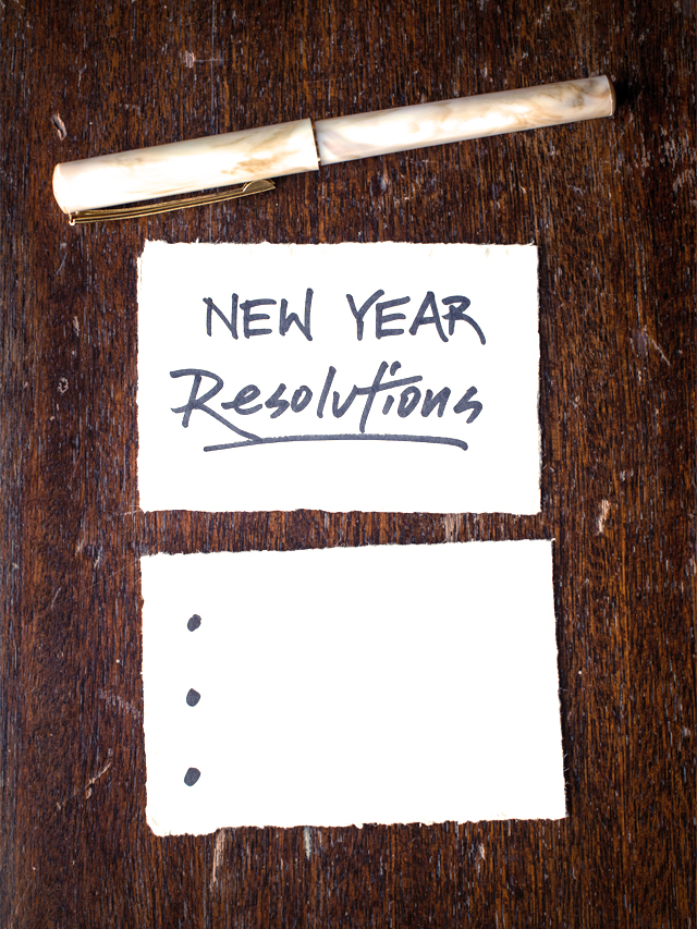 pen and paper with the words New Year Resolution written on the paper