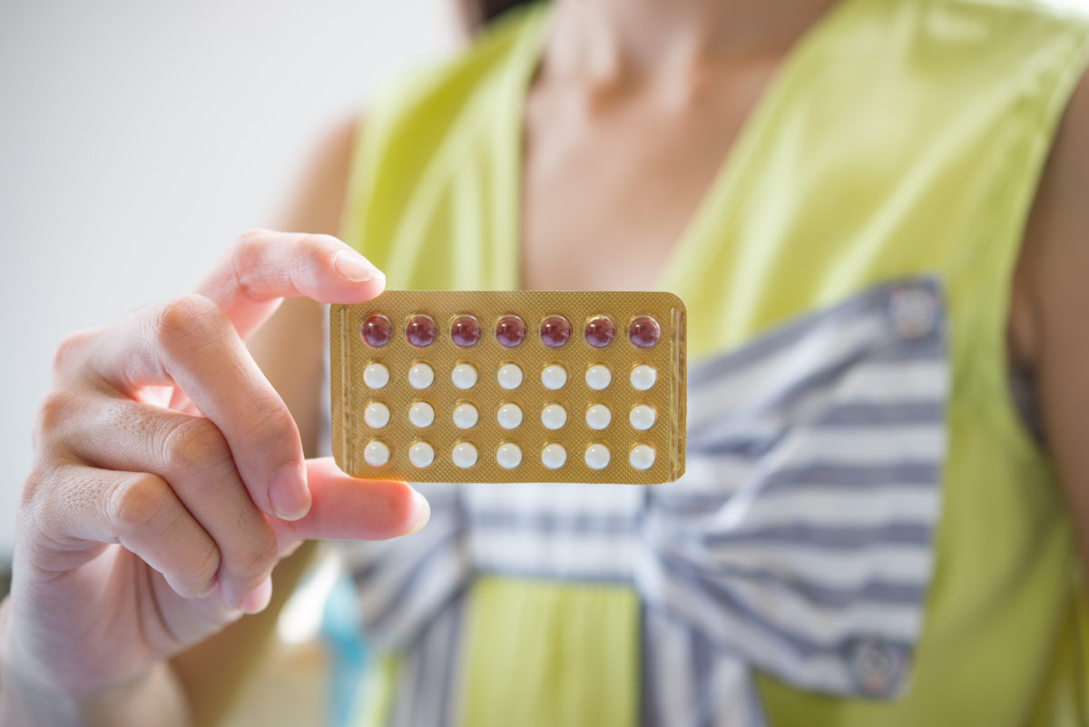 Woman hand holding a contraceptive pill packet