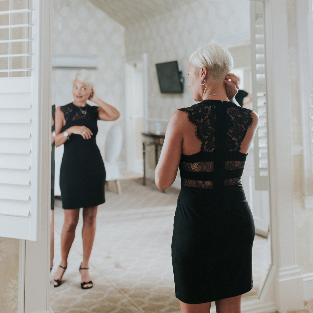 Woman looks at herself in the mirror