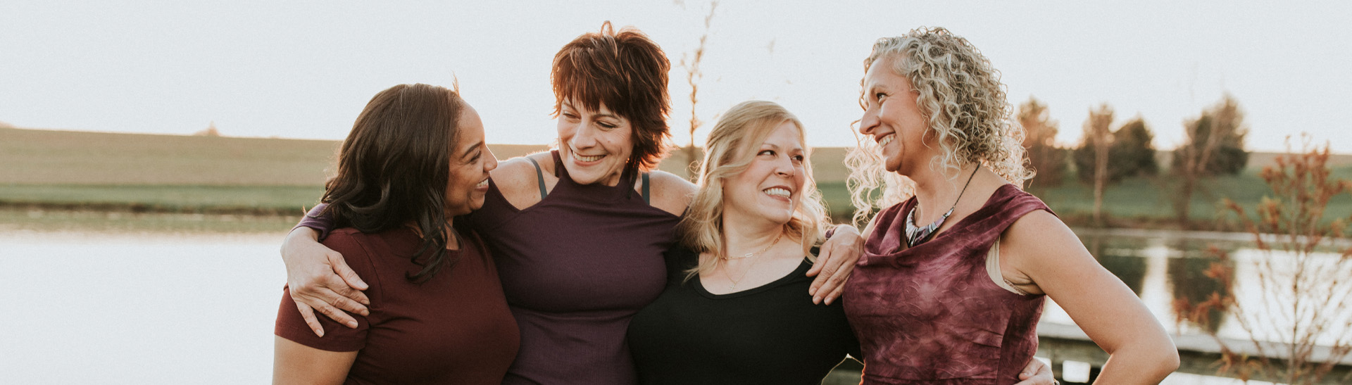 Four smiling middle-aged women