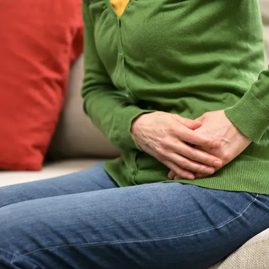 Woman holds painful stomach