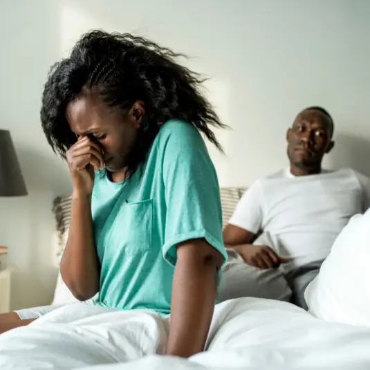 Woman upset and husband in bed